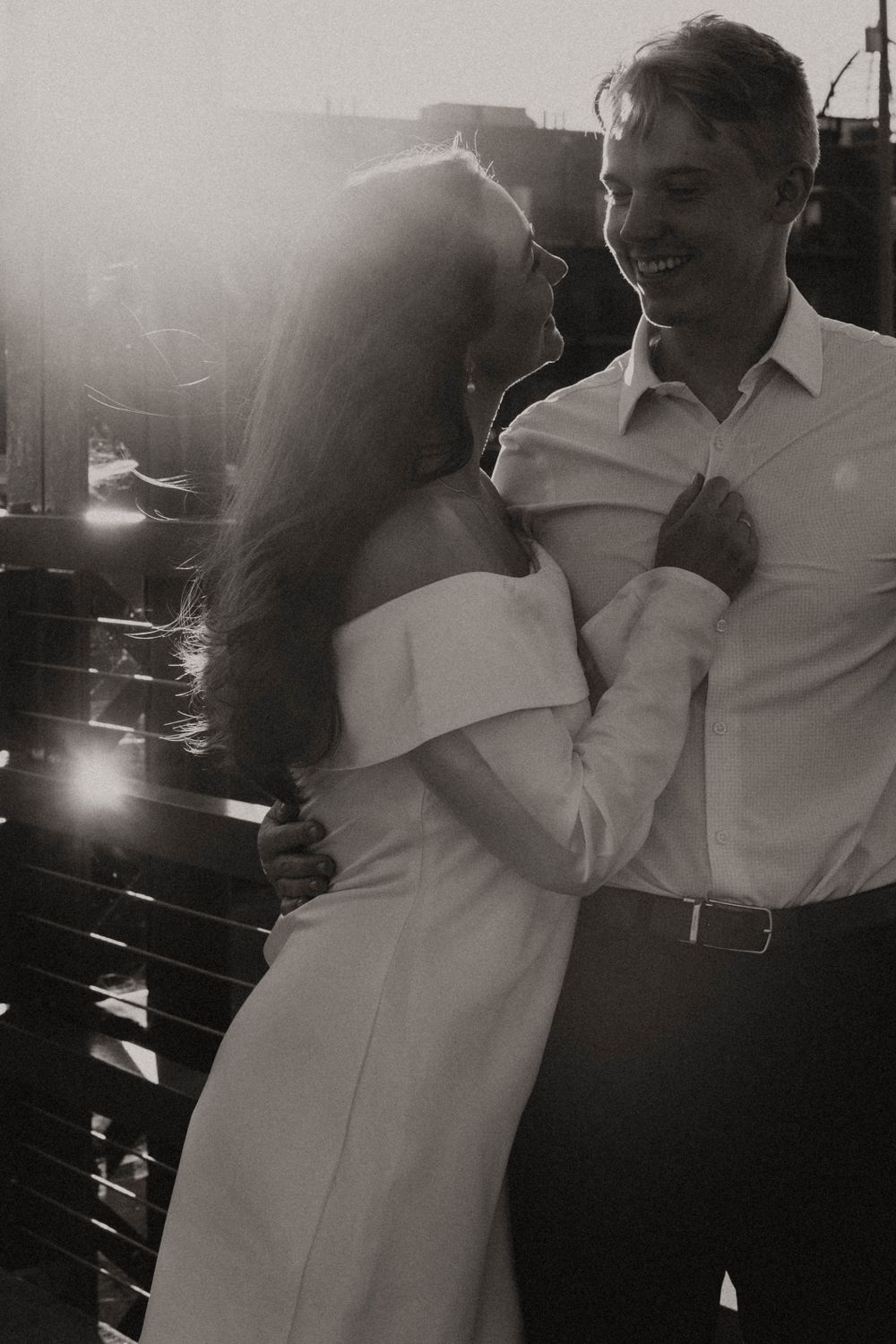 A black and white photo capturing an intimate dance moment in dim lighting.