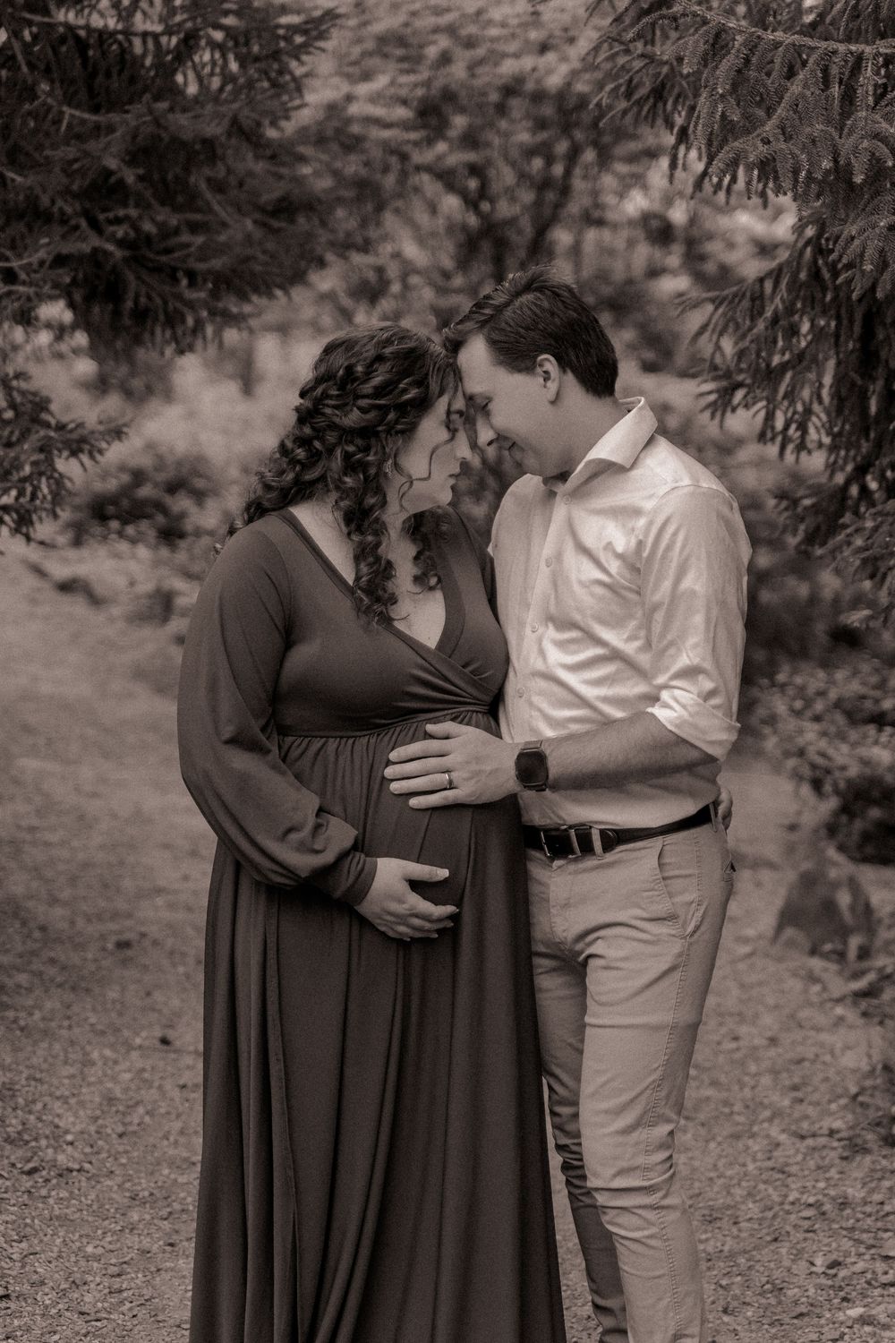 Black and white portrait of mother and father embracing each other during a maternity lifestyle session