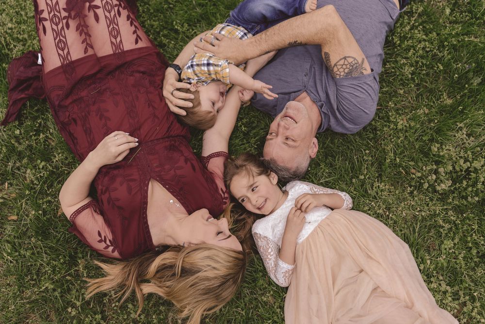 Family laying down together at the park during a lifestyle family session