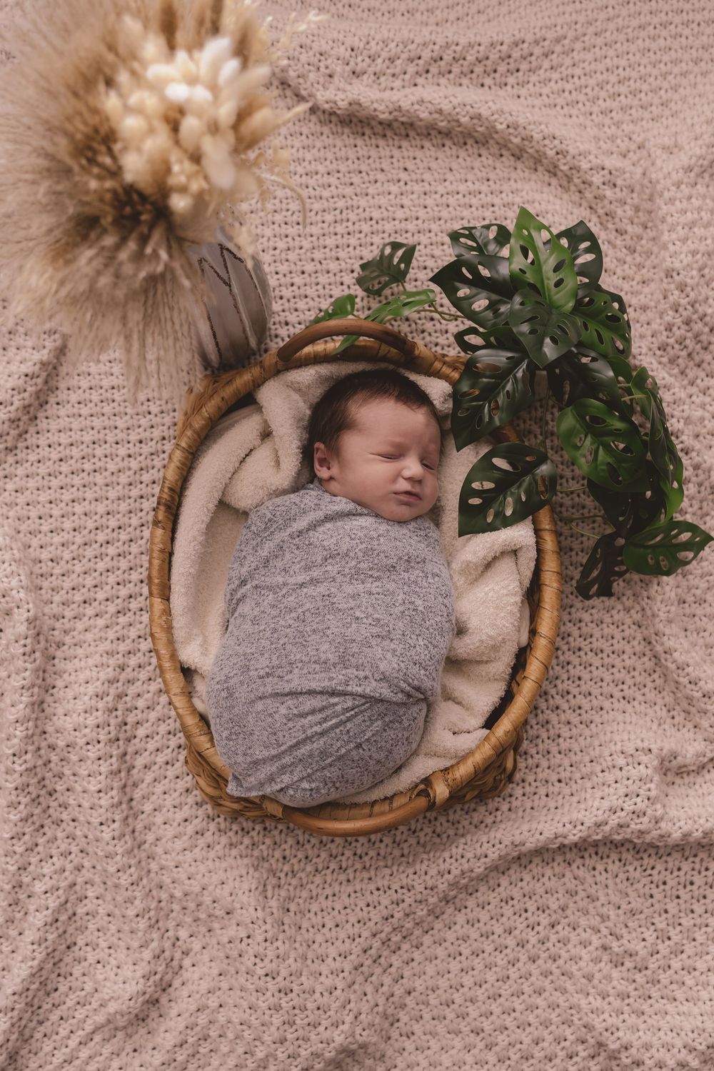 Newborn baby lying in a basket during a lifestyle newborn photography session in Charlotte, North Carolina