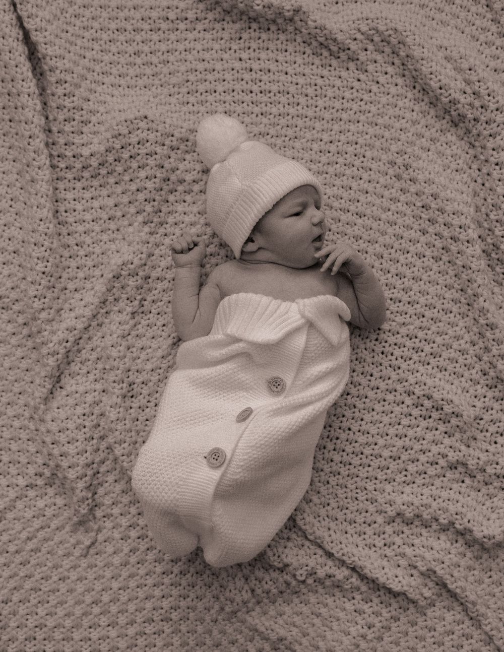 Newborn baby wearing a hat during a lifestyle newborn photography session in Charlotte, North Carolina