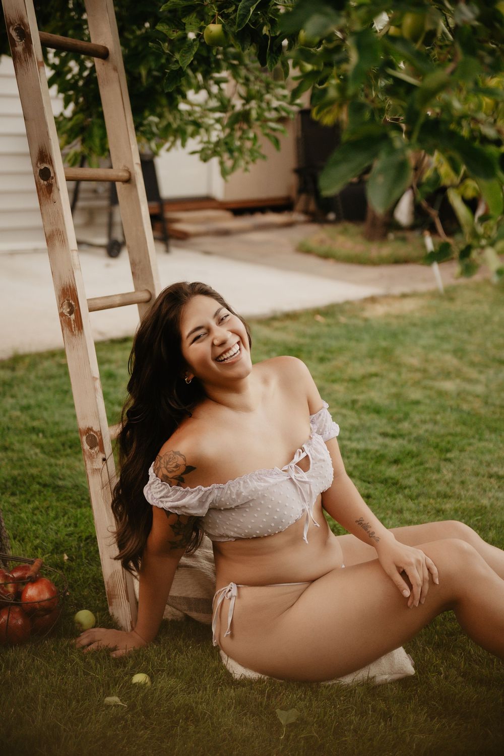Backyard Utah Boudoir photoshoot with cottagecore vibes. Apple Picking female model with a bright and airy vibe.