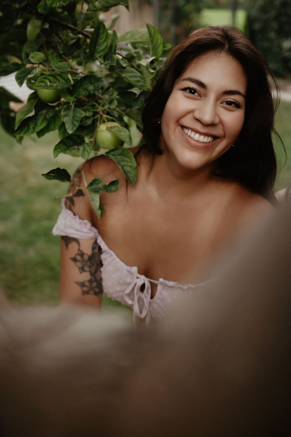 Backyard Utah Boudoir photoshoot with cottagecore vibes. Apple Picking female model with a bright and airy vibe.