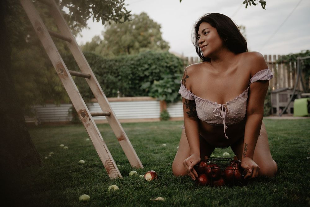 Backyard Utah Boudoir photoshoot with cottagecore vibes. Apple Picking female model with a bright and airy vibe.