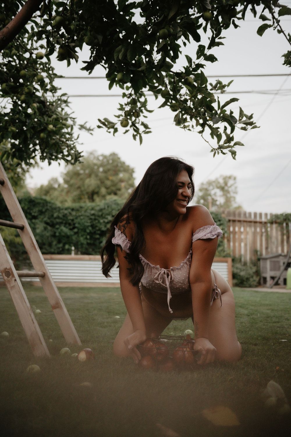 Backyard Utah Boudoir photoshoot with cottagecore vibes. Apple Picking female model with a bright and airy vibe.
