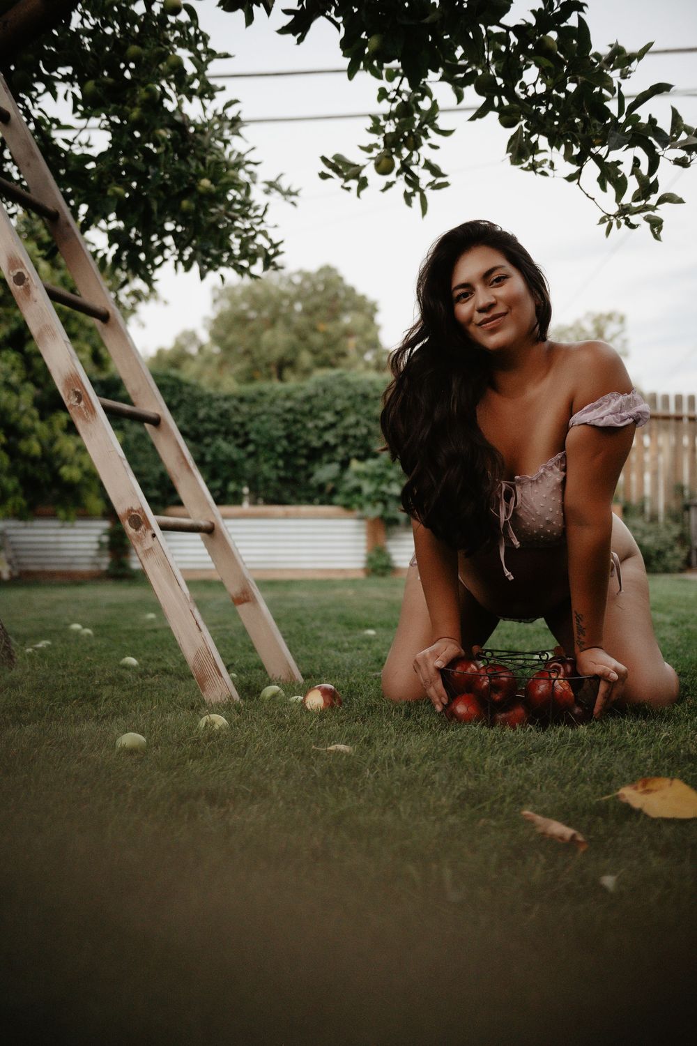 Backyard Utah Boudoir photoshoot with cottagecore vibes. Apple Picking female model with a bright and airy vibe.