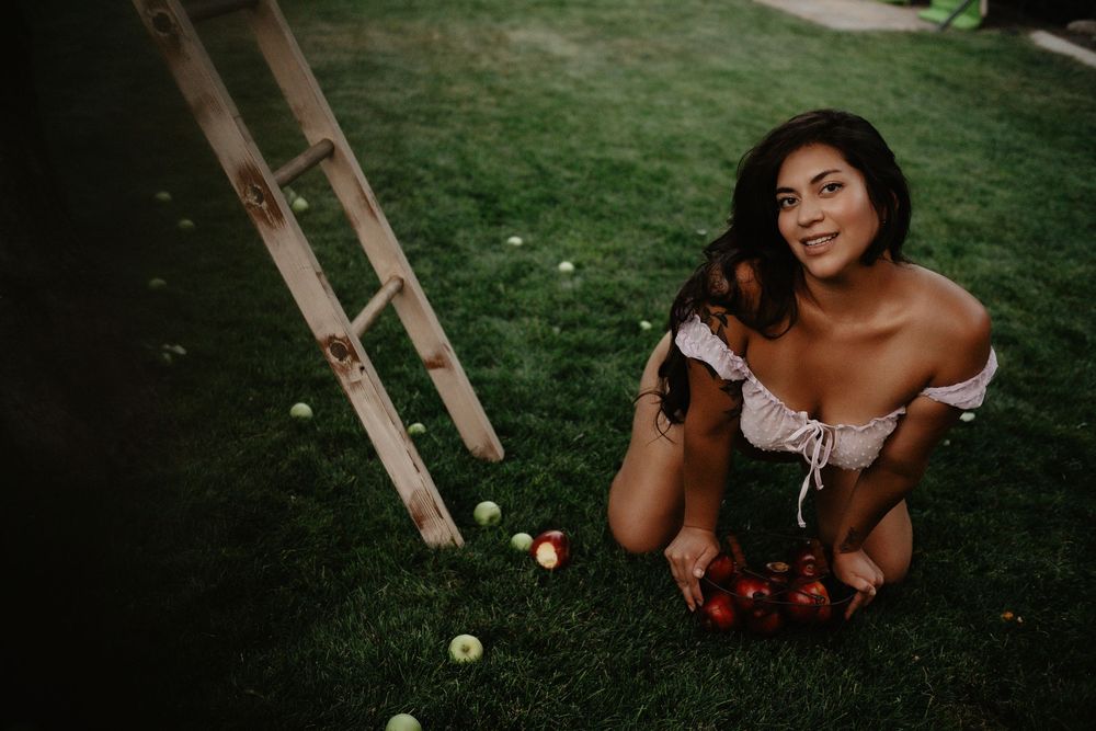 Backyard Utah Boudoir photoshoot with cottagecore vibes. Apple Picking female model with a bright and airy vibe.