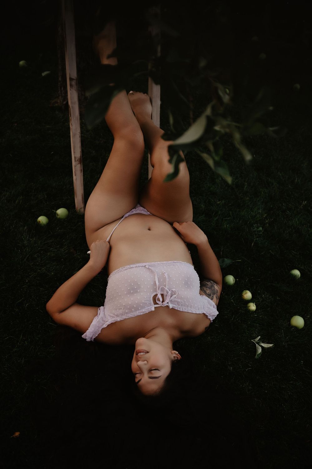 Backyard Utah Boudoir photoshoot with cottagecore vibes. Apple Picking female model with a bright and airy vibe.