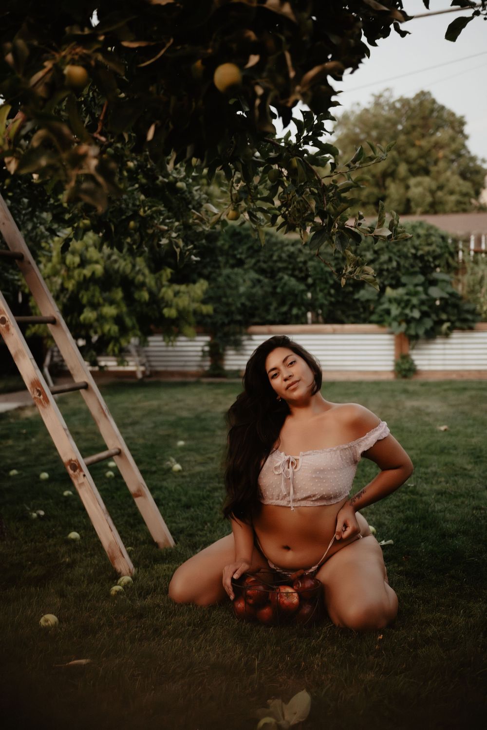 Backyard Utah Boudoir photoshoot with cottagecore vibes. Apple Picking female model with a bright and airy vibe.