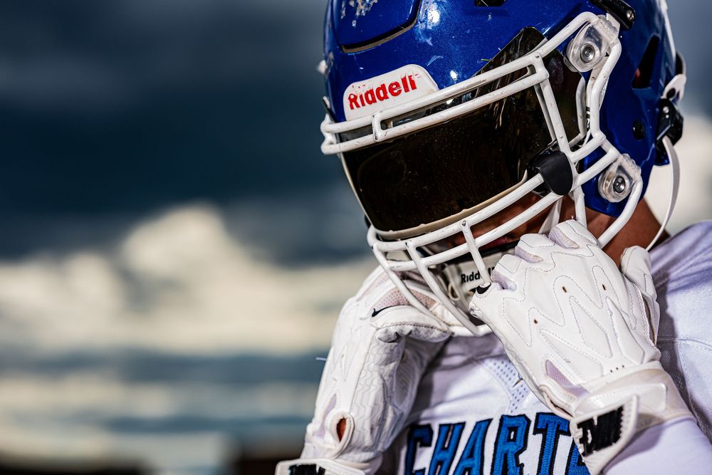 NFL player wearing a blue and white New York Giants uniform targets an opposing player during a game.