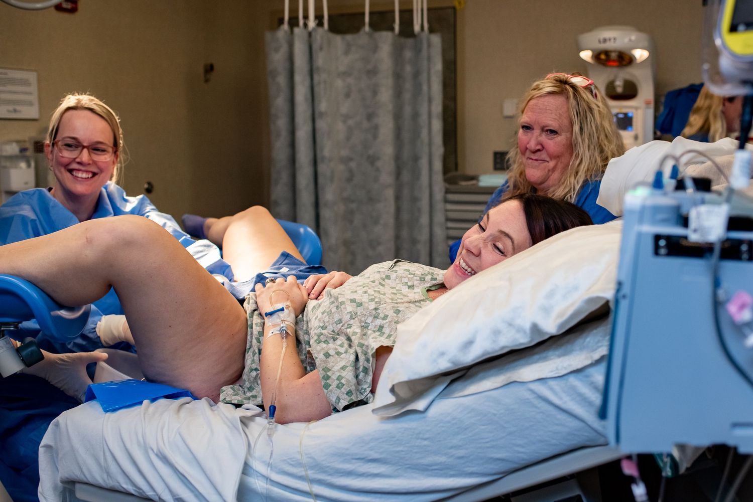 Healthcare providers support patient during active labor in hospital setting.