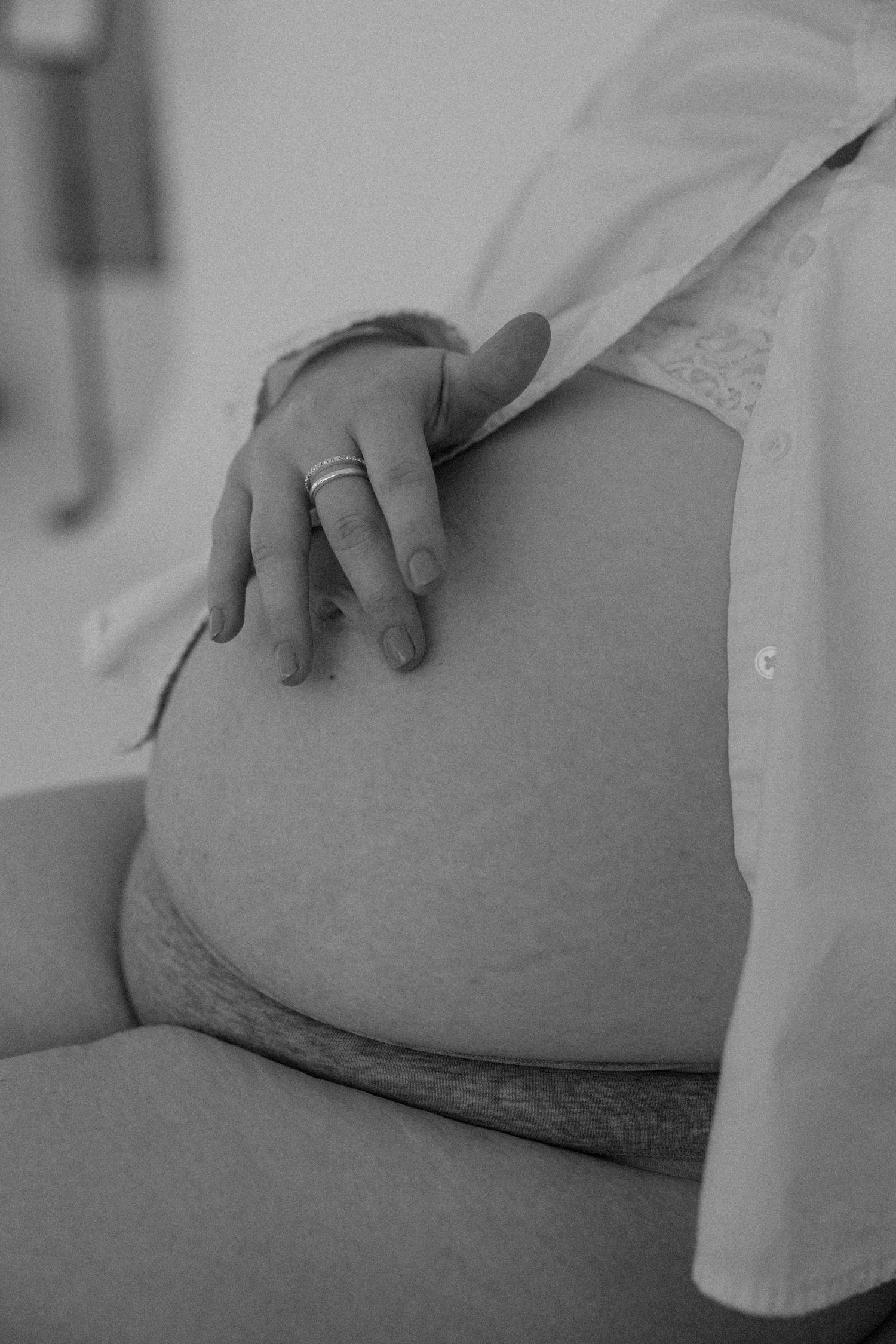 Close up maternity photo of belly in a Gallery 48 in Rochester, NY.