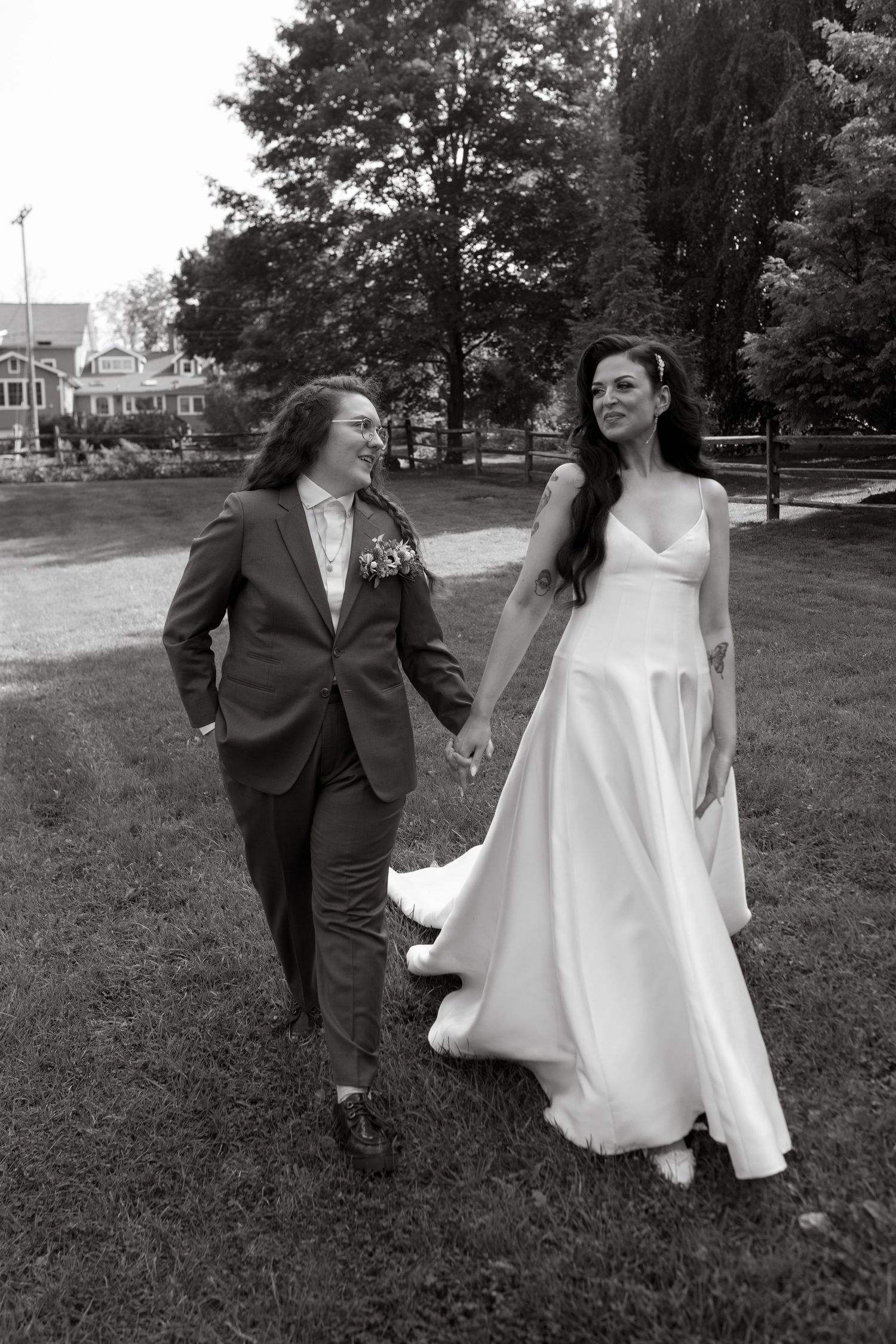 A joyful couple shares a laugh during their outdoor garden wedding ceremony.