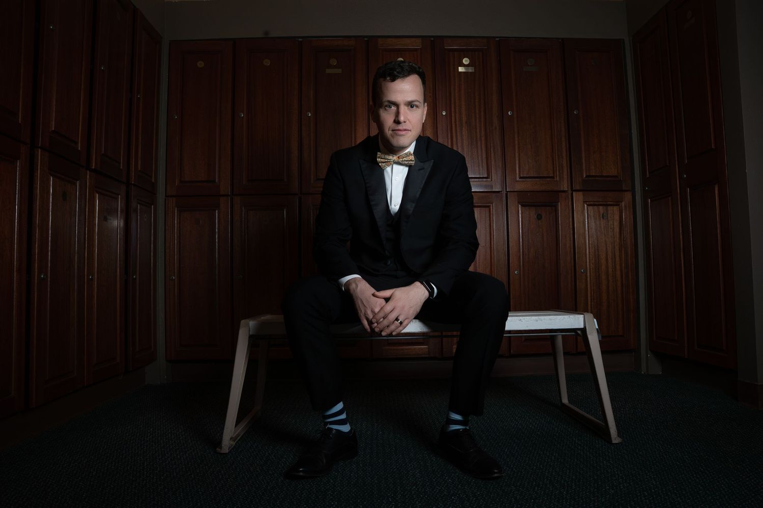 Groom sitting in the men's locker room at the Yolo Fliers Club in Woodland, California. Photo by Ashley Baeza, Woodland Wedding Photographer