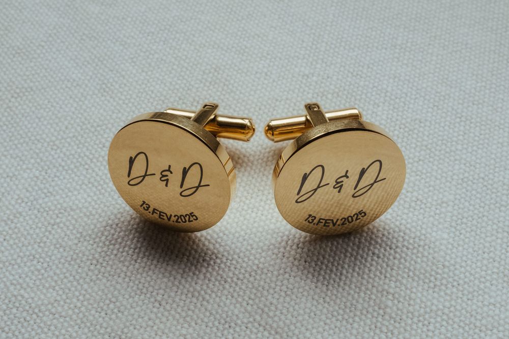 Gold round cufflinks engraved with initials D&D and a date, perfect for a wedding or anniversary gift.