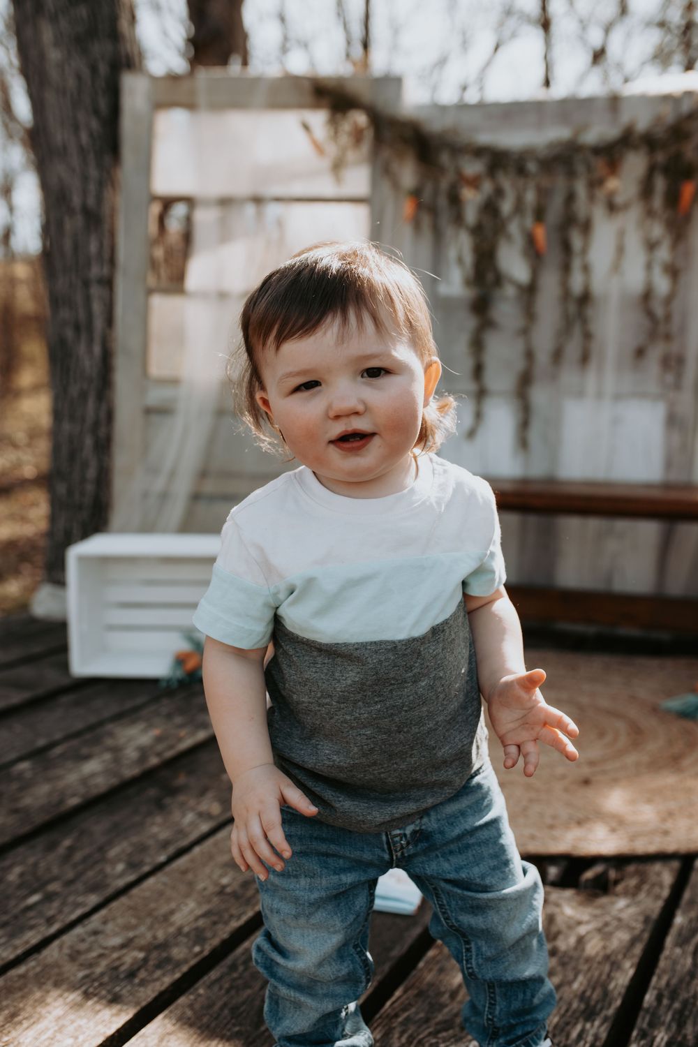 Playful poses on a wooden deck wearing a two-toned outfit.