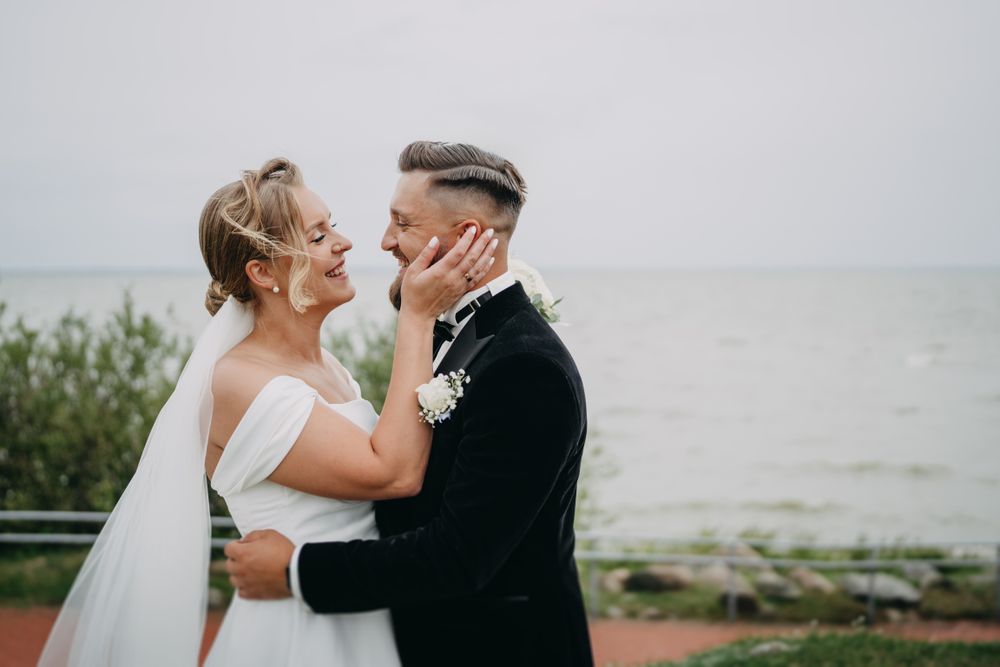 Romantic outdoor wedding portraits with natural lighting and ocean backdrop.
