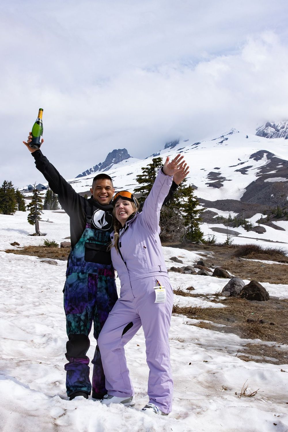 Two snowboarders celebrate with champagene on Mount Hood in Oregon,