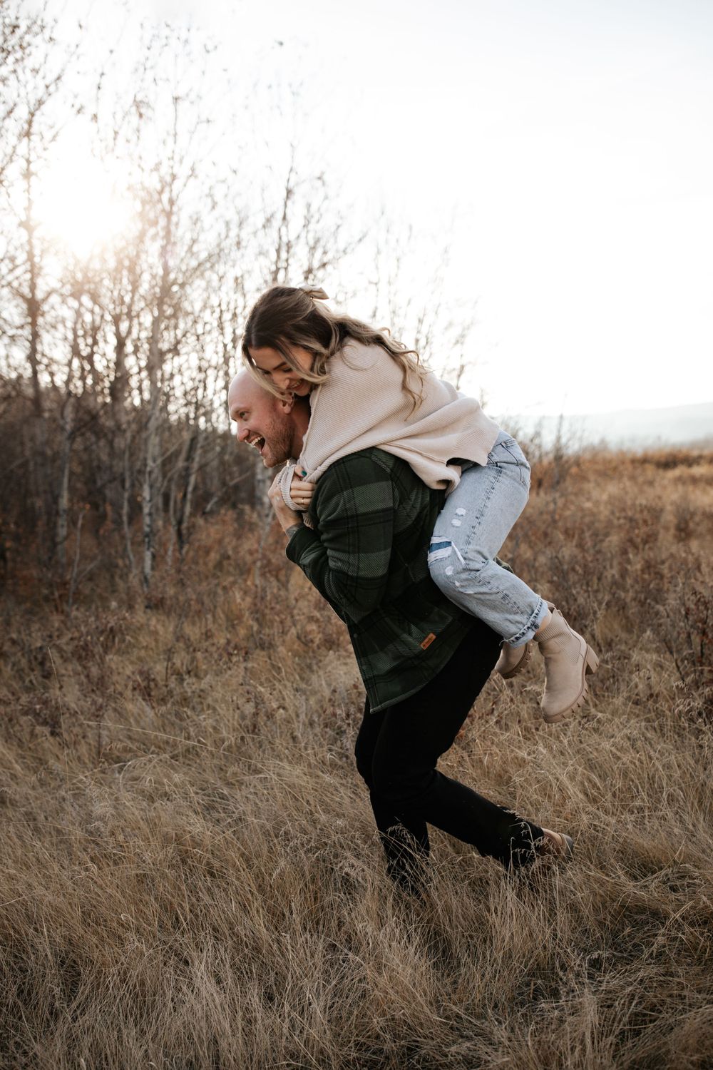 A joyful piggyback ride moment captured in autumn field.