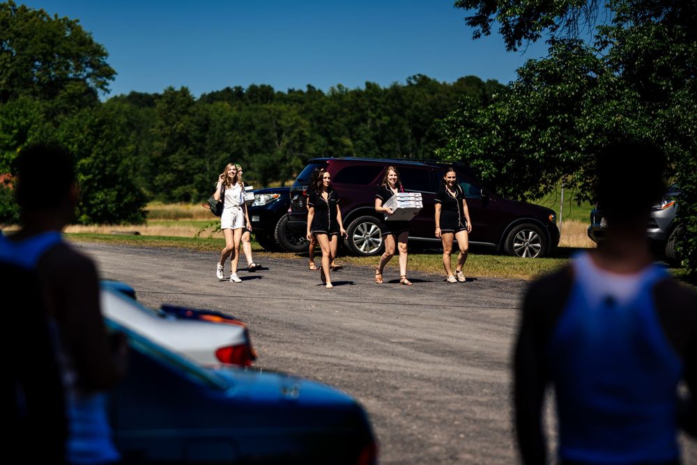Bride & Bridesmaids arriving with pizza before getting ready.