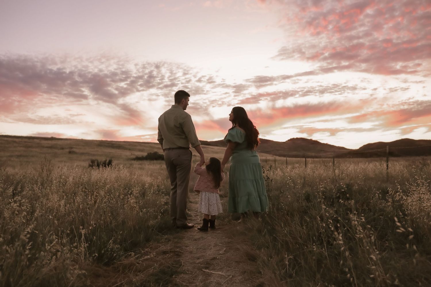 family with their daughter walking off into the sunset