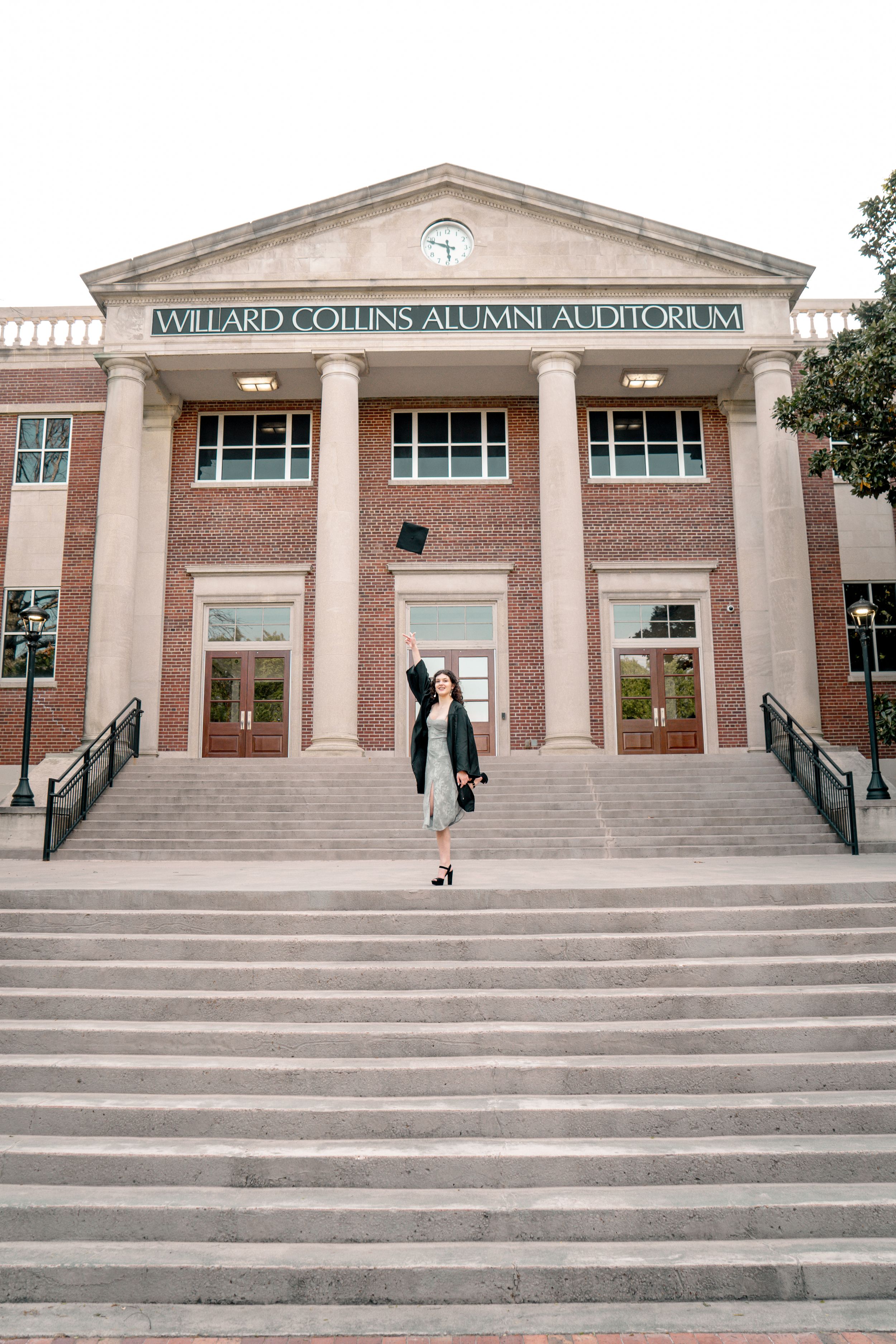 A panoramic view of the Willard Collins Alumni Auditorium entrance with brick walls and white columns.