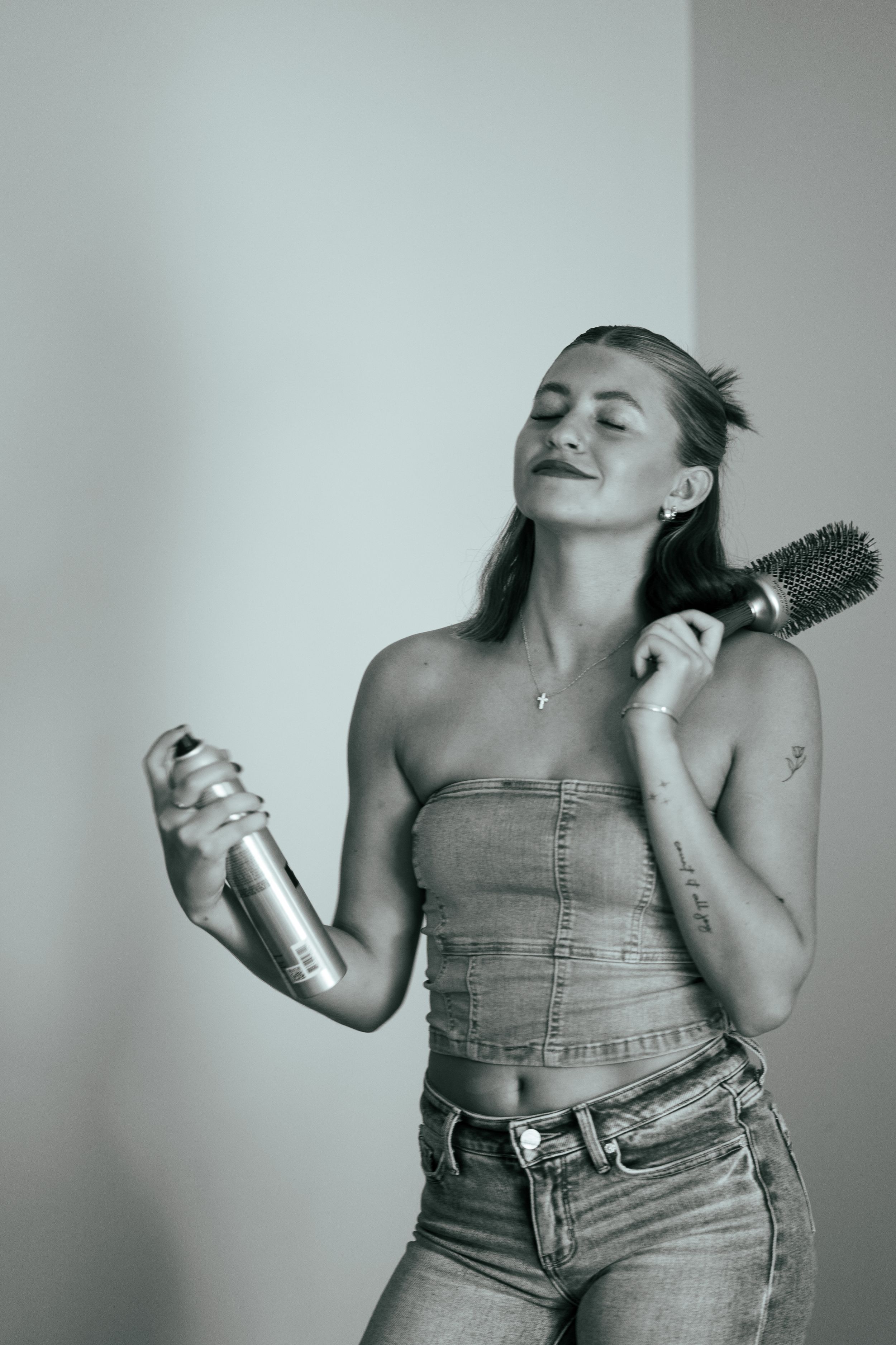 Black and white photo series showing a person in denim overalls dancing and moving expressively against a light background.