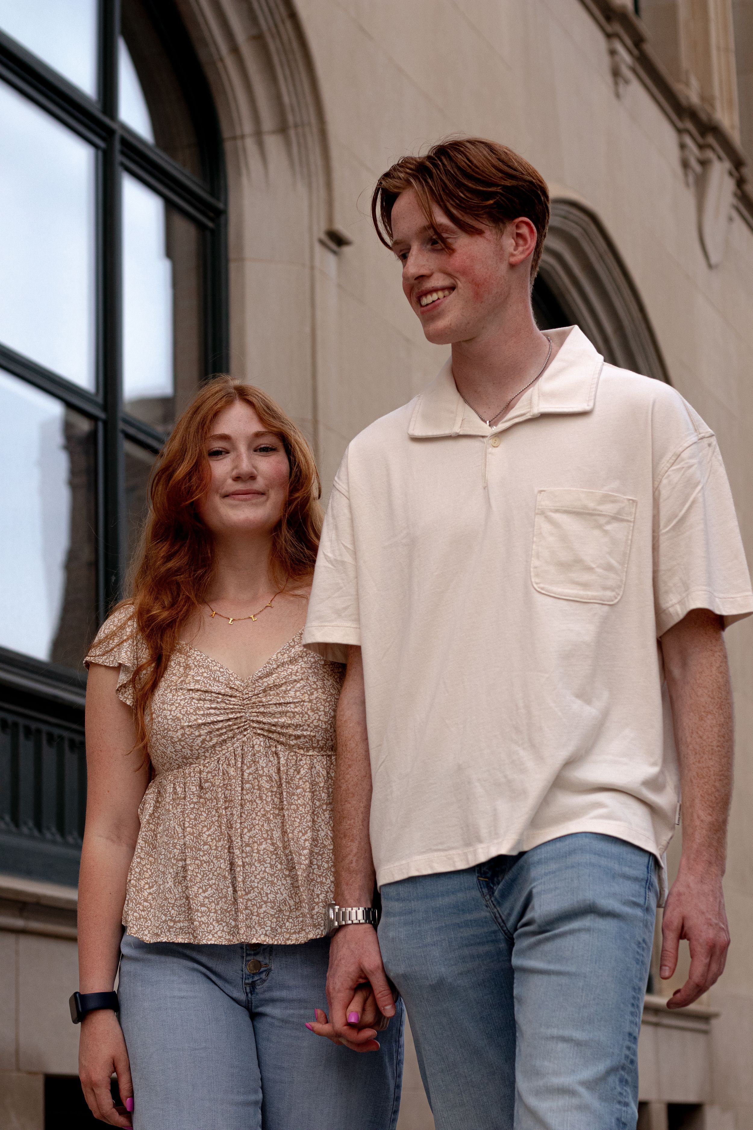 Romantic couple photoshoot outside classic architecture with white walls.