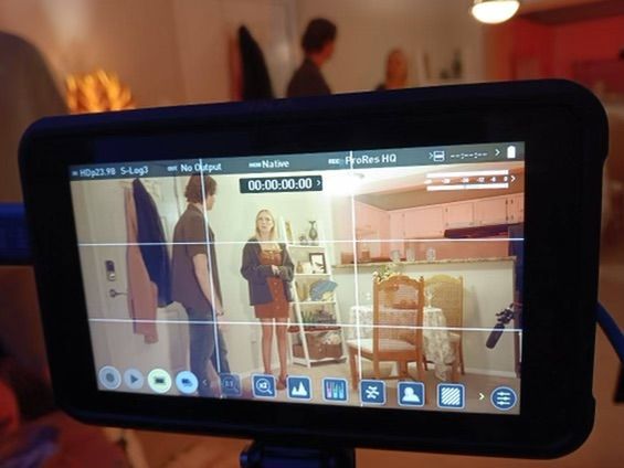 Production crew and camera equipment set up in a room with colored lighting.Eat me Baby! Student Short film still by Lucca Vieira cinematogr