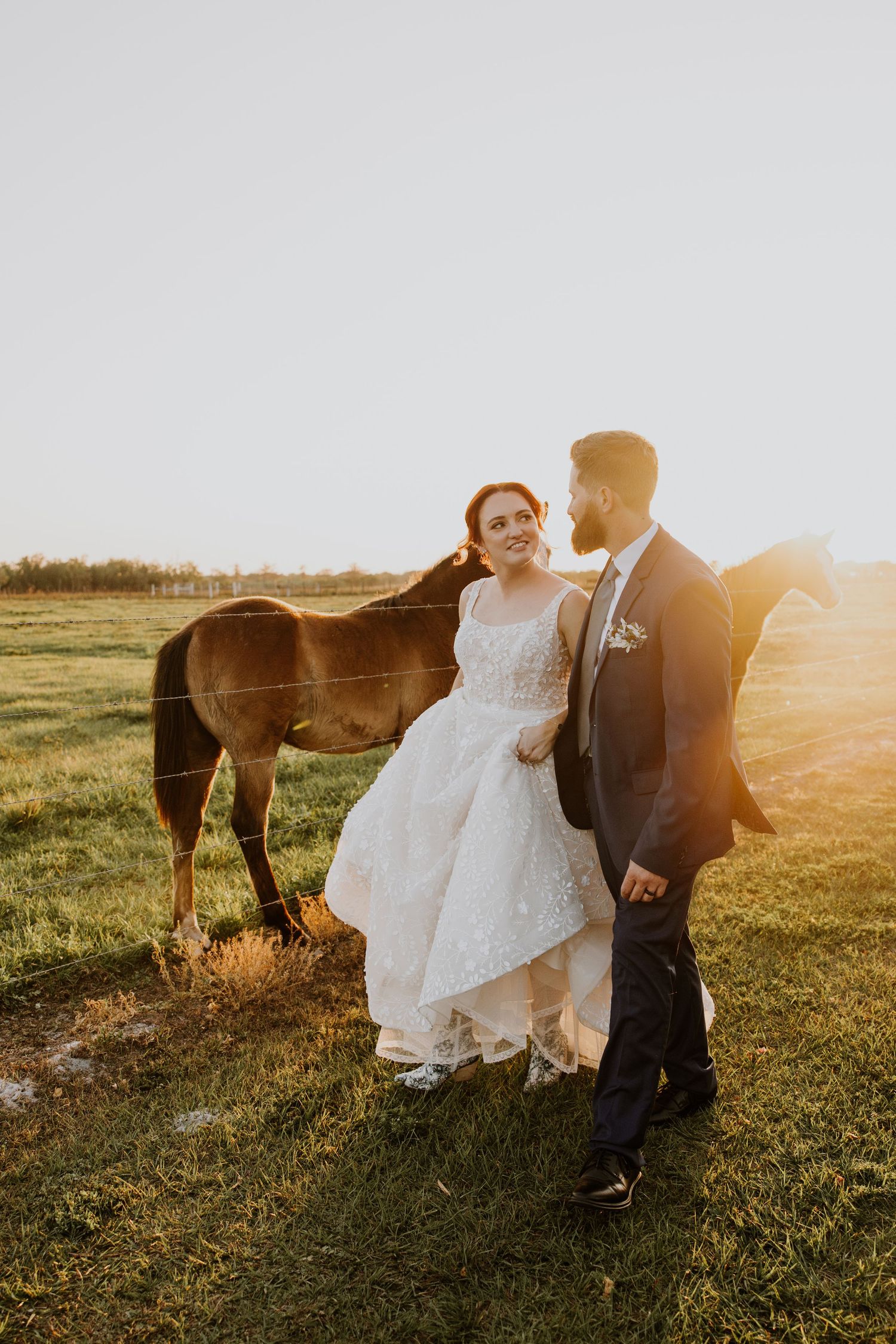 Bride and groom at sunset wedding Ever After Farms Stockyard Barn captured by Lindsay McDow Photography. Top Knot Artistry, DJ Last Call