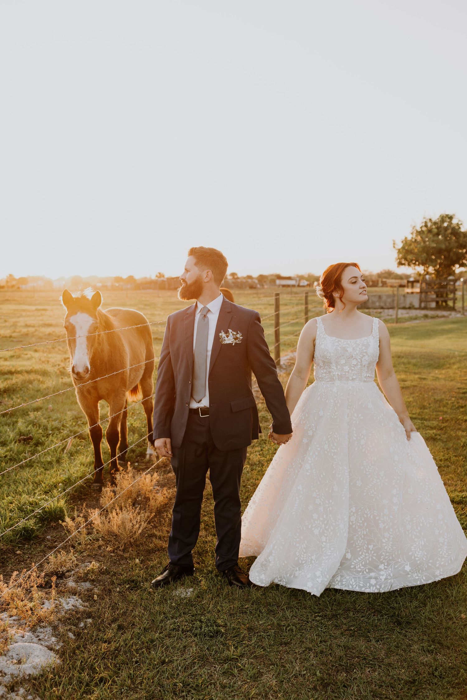 Bride and groom at sunset wedding Ever After Farms Stockyard Barn captured by Lindsay McDow Photography. Top Knot Artistry, DJ Last Call