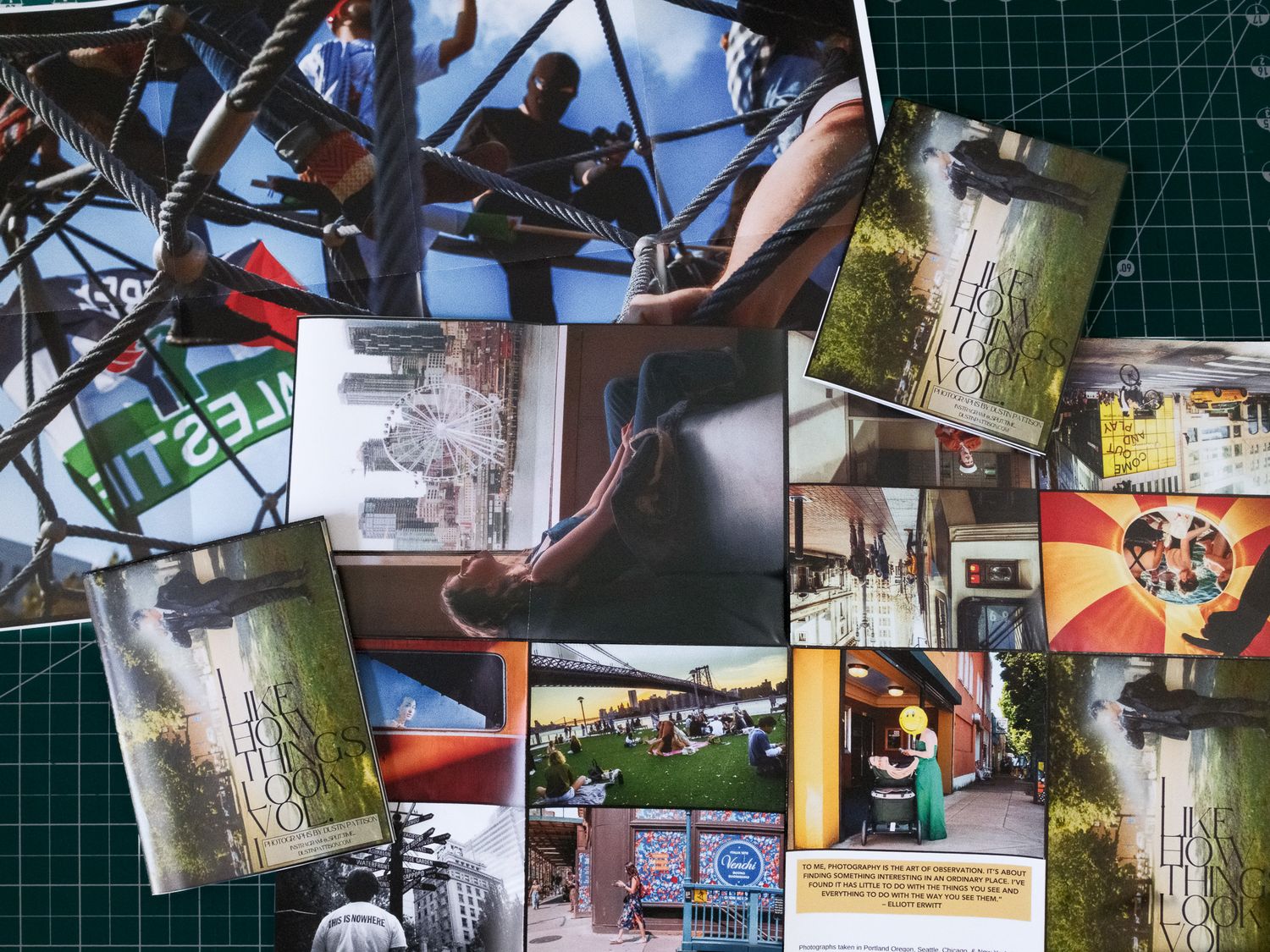 A scattered collection of photographs and prints displayed on a dark green surface shows various outdoor and nature scenes.