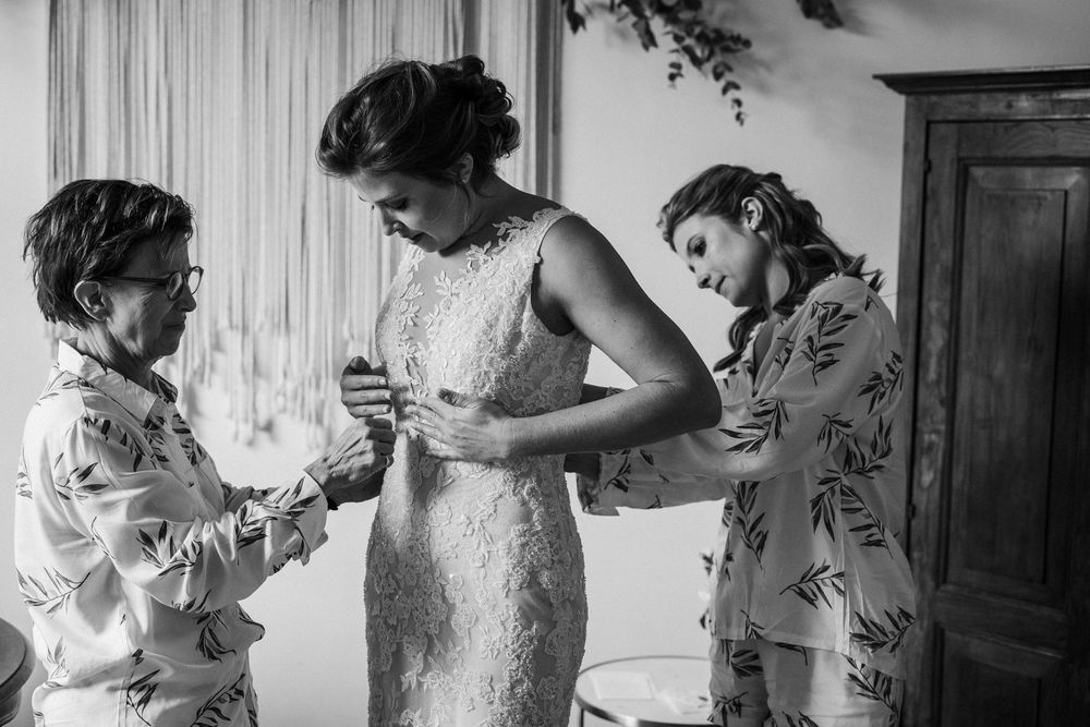Black and white photography sequence showing intimate wedding day preparation moments in a light filled room.