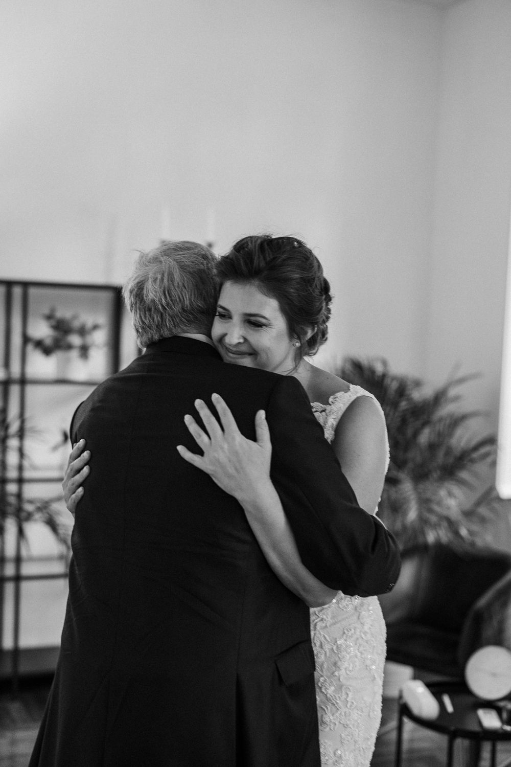 Emotional embraces between loved ones captured in a series of black and white wedding photographs.