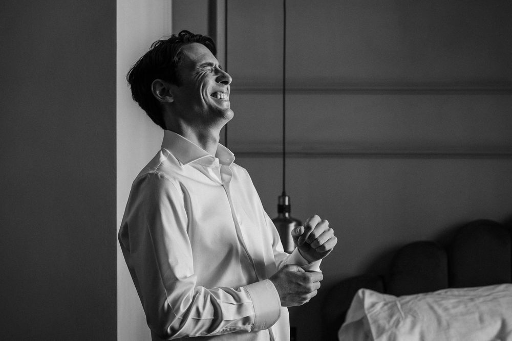 Series of candid black and white portraits showing joyful laughter and natural expressions.