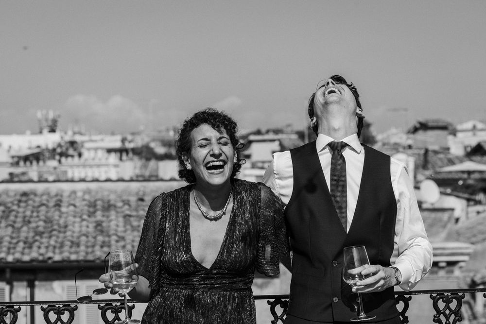Black and white candid shots of wedding guests enjoying themselves at an outdoor reception.