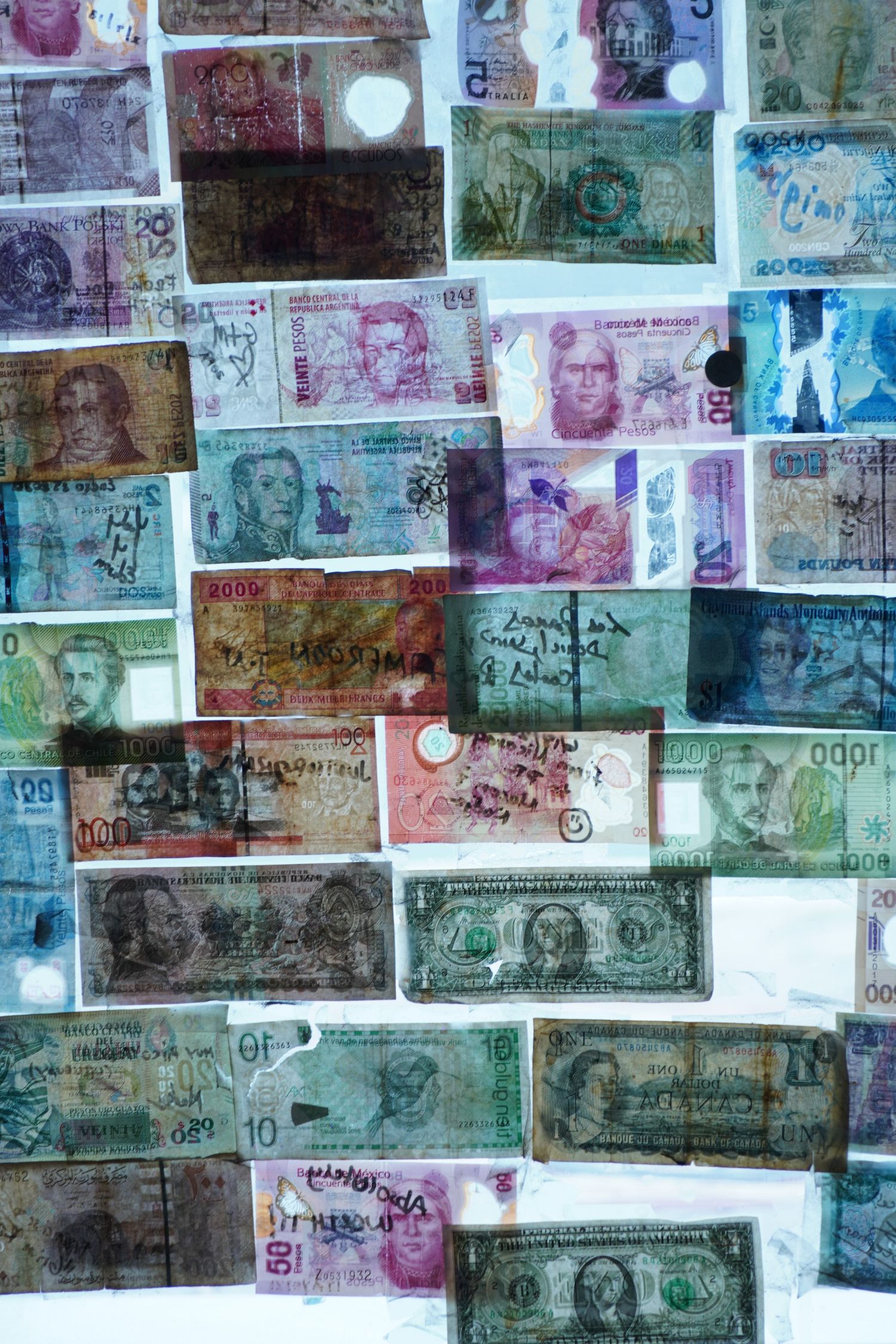 Collection of international paper currency bills from various countries displayed in an overlapping collage arrangement.