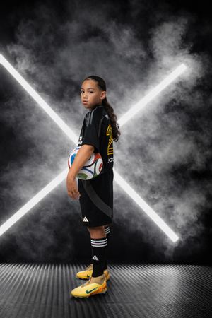 Dynamic sports photo sequence showing athletic poses against a dramatic black background with glowing X-shaped lights.