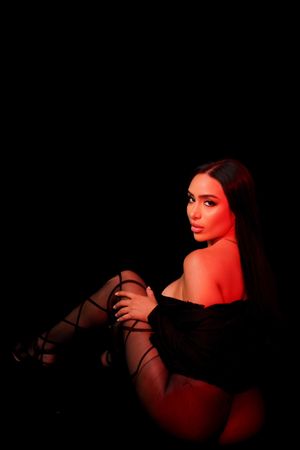 Moody portrait series with dramatic red lighting against black background.