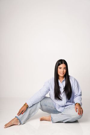 Person in light blue loungewear lying on white background in various relaxed poses.