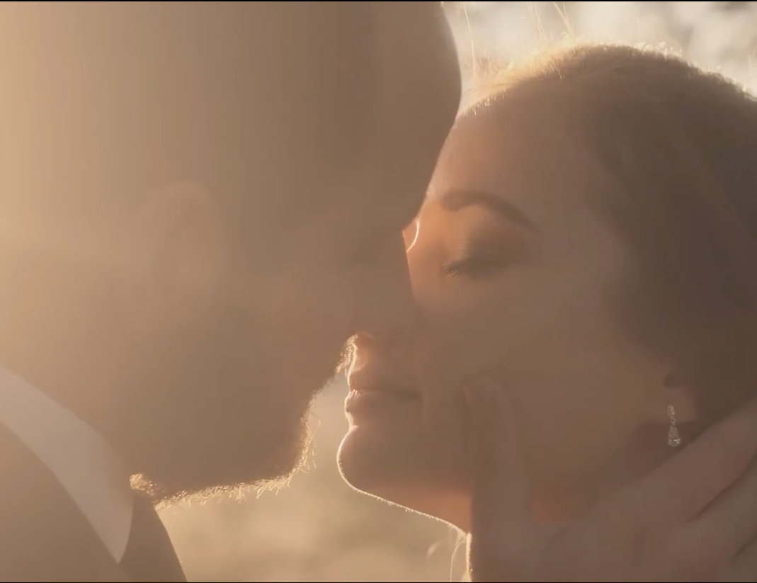 Intimate close-up of couple in dreamy golden light.