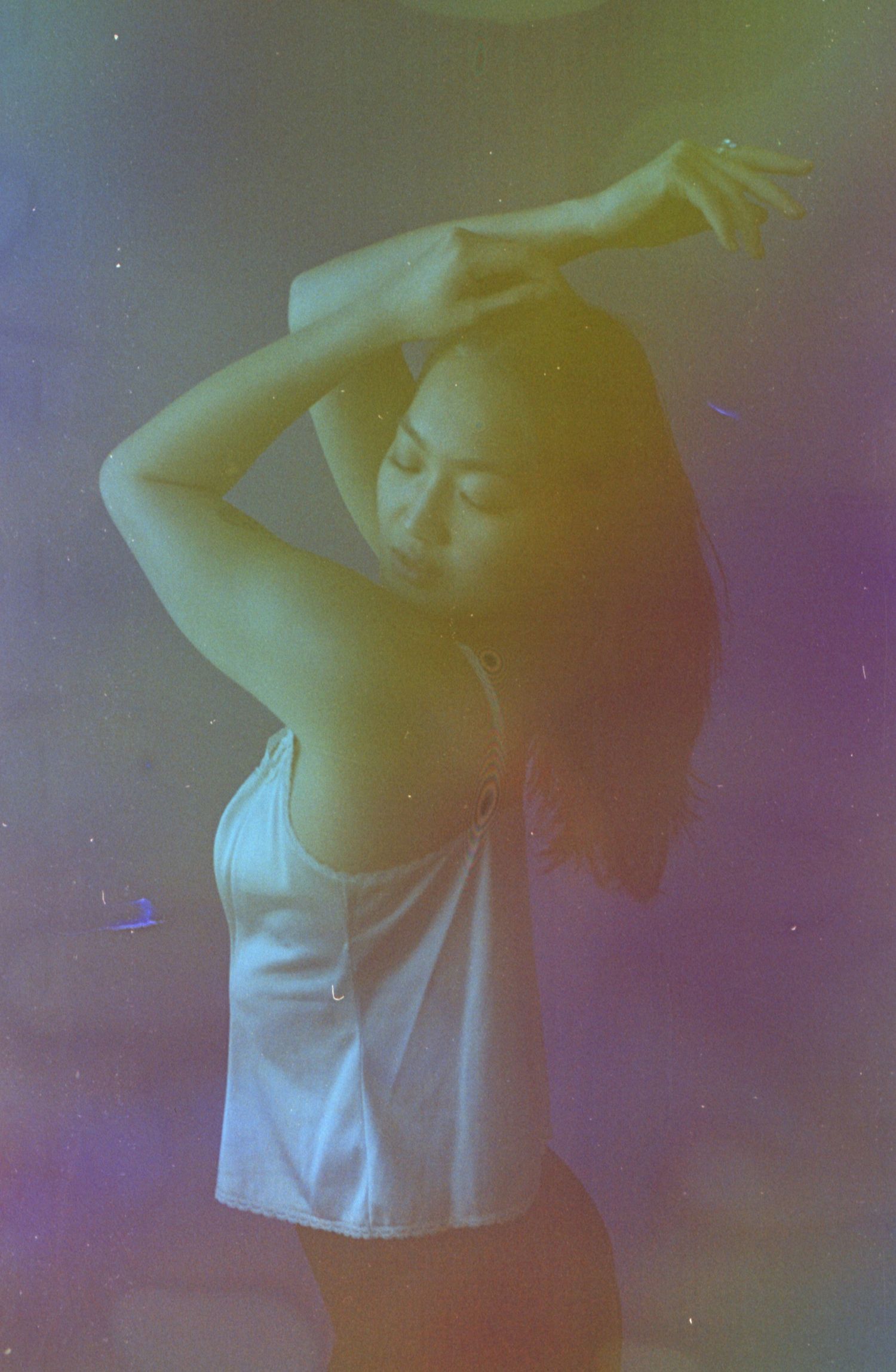 Graceful movement captured in vintage-style portrait with rainbow color effects.