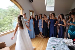 Wedding guests gather together in a bright studio space for a joyous celebration and photoshoot.