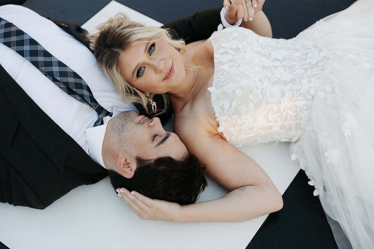 Elegant wedding scene in a room with wooden windows and an upright piano, featuring a vintage style setting with natural lighting.