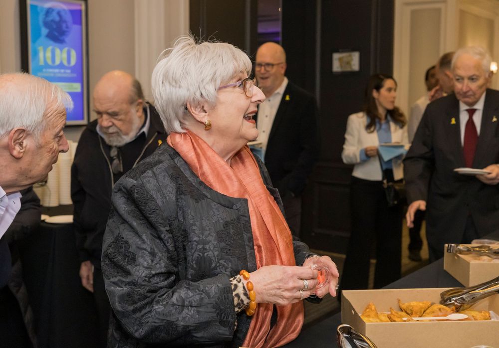 Sequence of four candid shots showing seniors enjoying a social gathering at a banquet hall together.