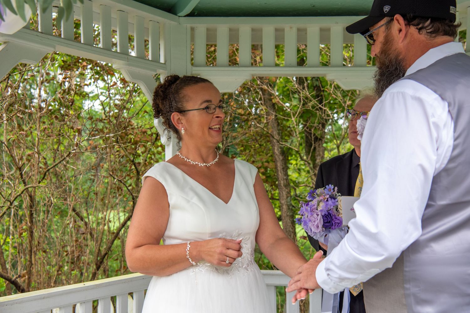 Couple shares a romantic first dance moment outdoors during their wedding celebration.