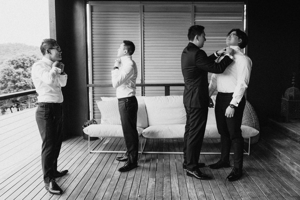 Black and white image of formal preparation before a wedding ceremony on a deck.