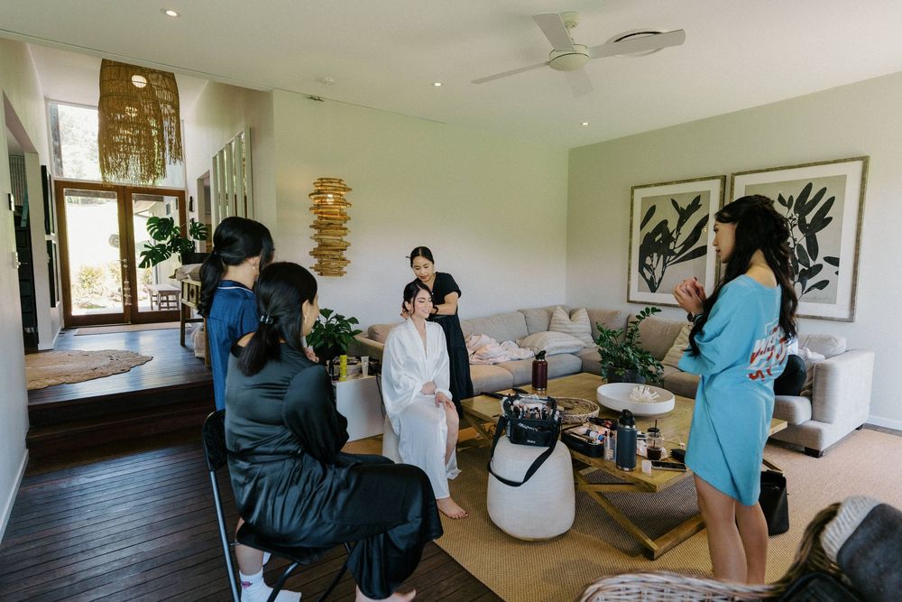 A panoramic view of a modern room with people preparing for a special event.