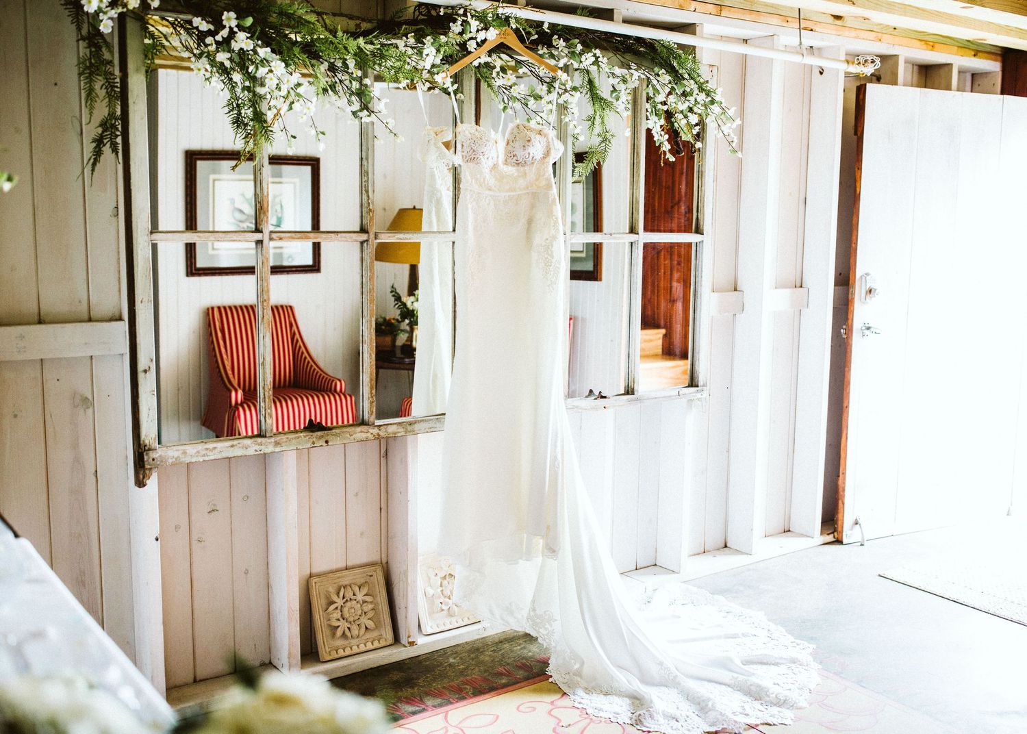 Light-filled rustic room with white walls and wooden accents decorated for a wedding.