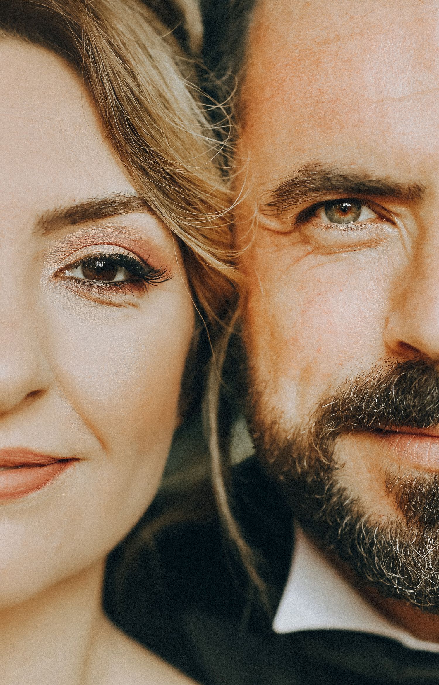 Close up artistic portrait series showing fragments of two faces in warm sunlit tones against dark background.